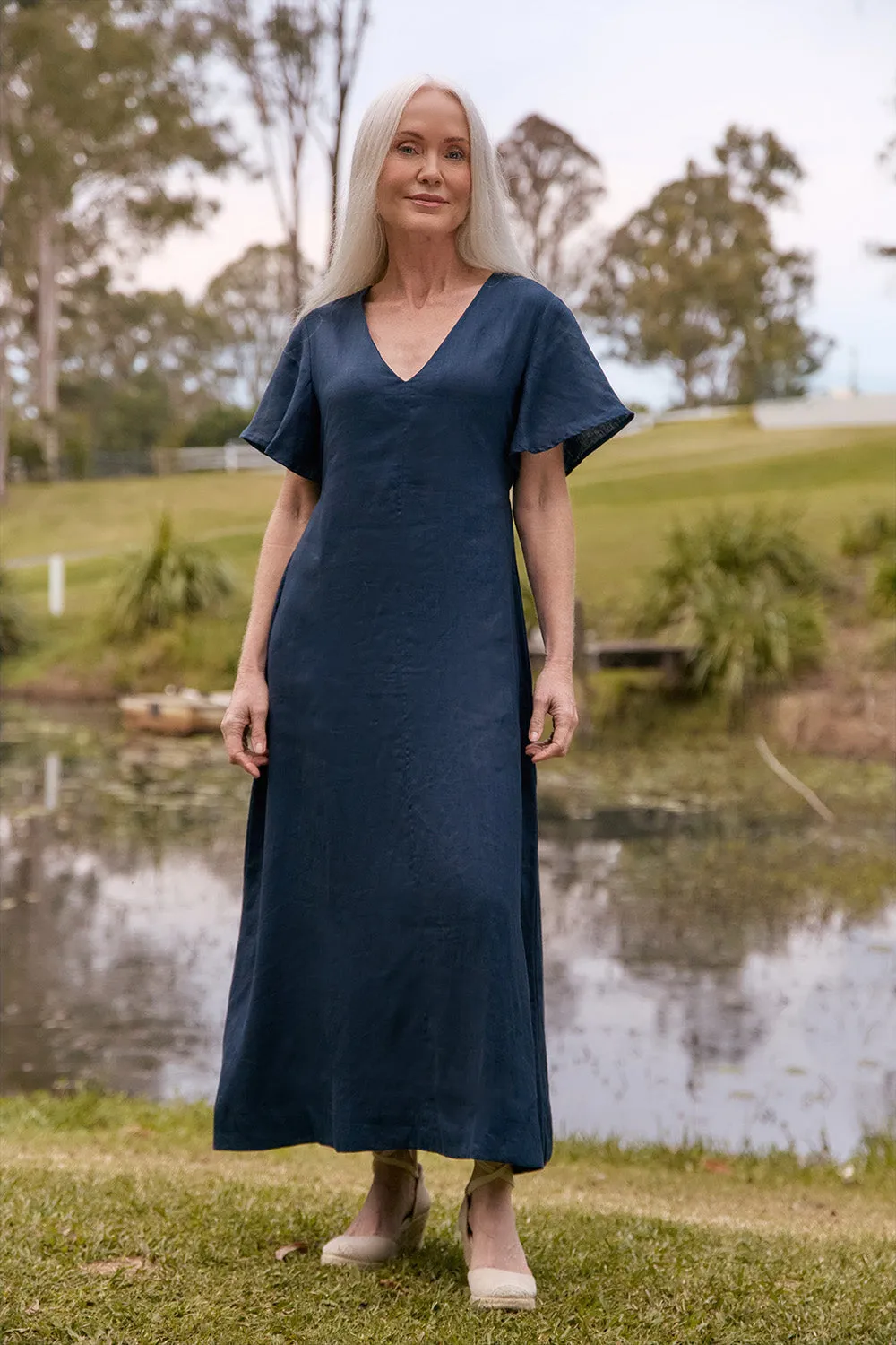 Tatum Linen Flutter Sleeve Dress in Navy The flattering design of this dress ensures it enhances your shape while providing comfort Feather Glow