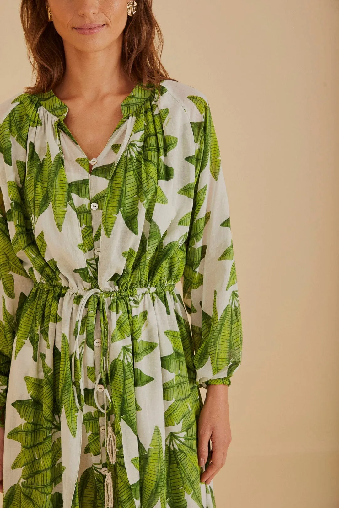 This dress creates a flattering silhouette while remaining breathable and comfortable Tide Glow Off-White Palm Fan Maxi Dress